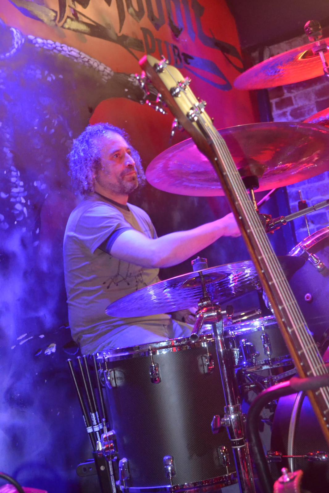 Hexblood drummer mid-performance under blue and red stage lights